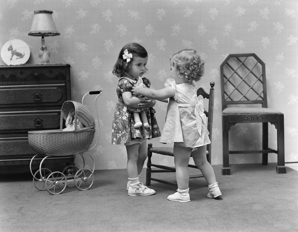 Detail of 1940s two girls playing with dolls by Corbis