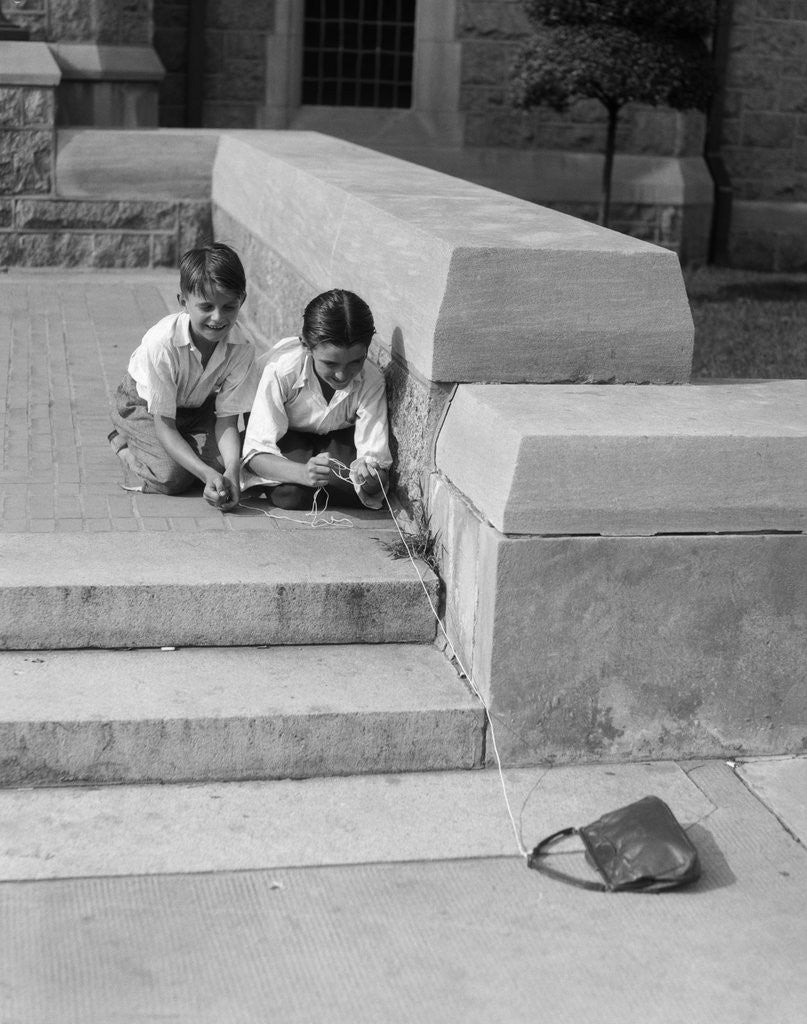 Detail of 1930s two boys playing trick with string tied to lost purse by Anonymous