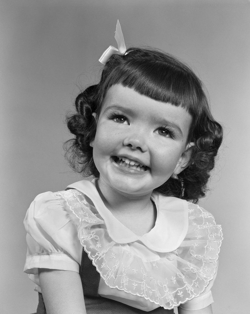 Detail of 1950s smiling brunette girl with bangs by Anonymous