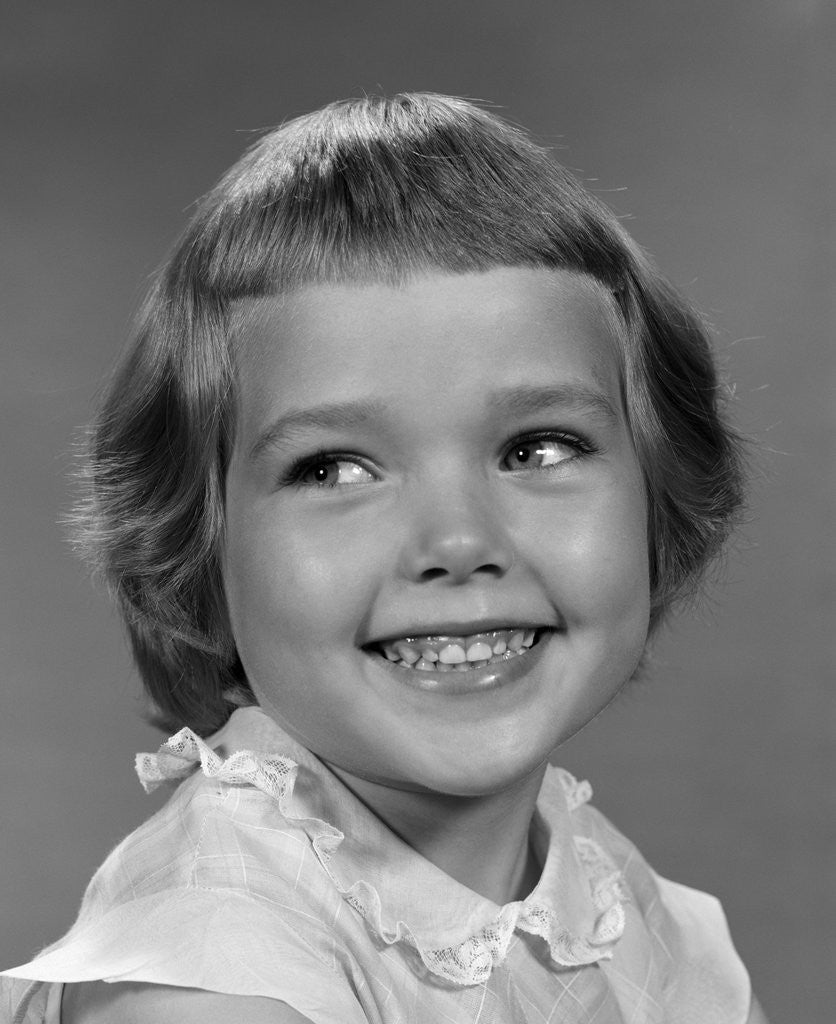 Detail of 1960s smiling girl looking off to the side by Anonymous