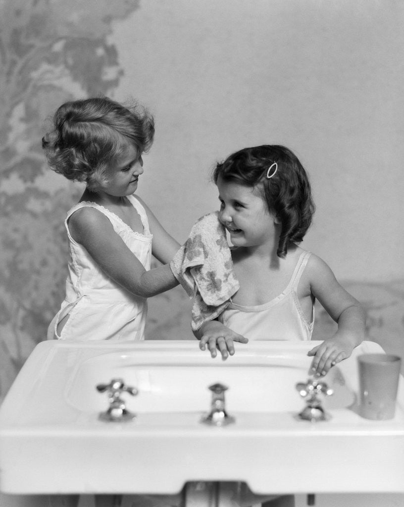Detail of 1930s two girls sisters at bathroom sink by Anonymous