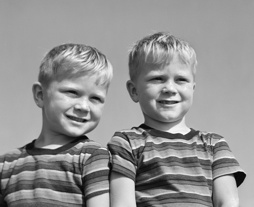 Detail of 1950s portrait two twin blond boys smiling wearing striped tee shirts brothers by Anonymous