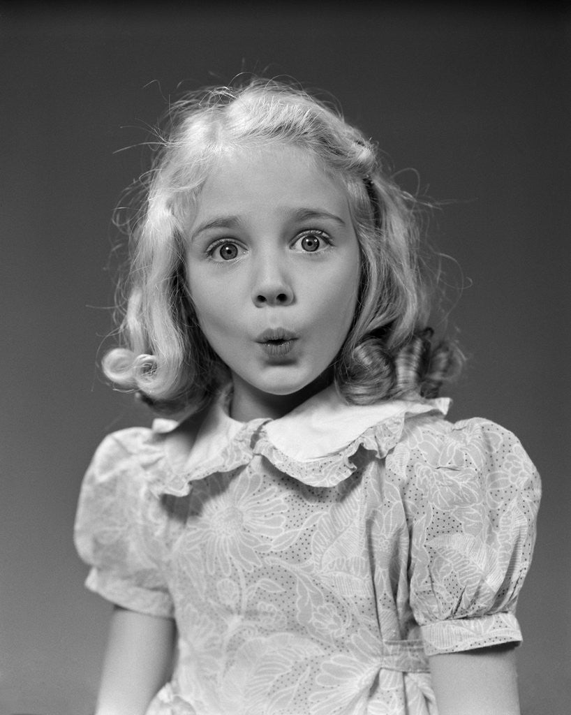 Detail of 1940s 1950s blond girl whistling lips puckered eyes wide open looking at camera by Anonymous