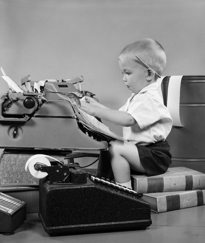 Detail of 1950s child typing sitting at typewriter by Anonymous