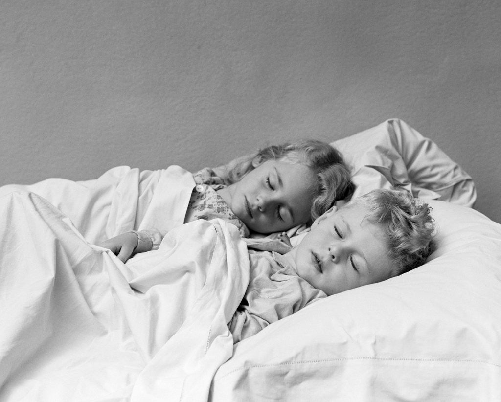 Detail of 1940s two children boy and girl sleeping in bed by Anonymous