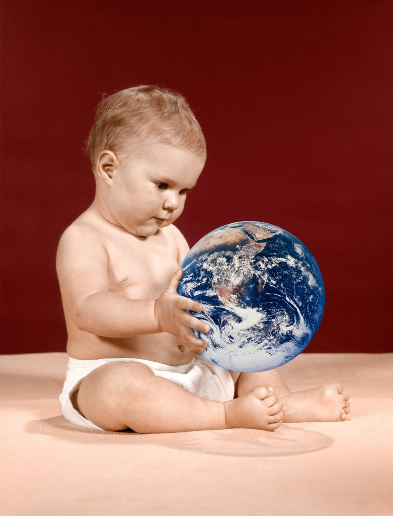 Detail of 1960s symbolic ecology serious baby wearing cloth diapers sitting holding looking at the earth by Anonymous