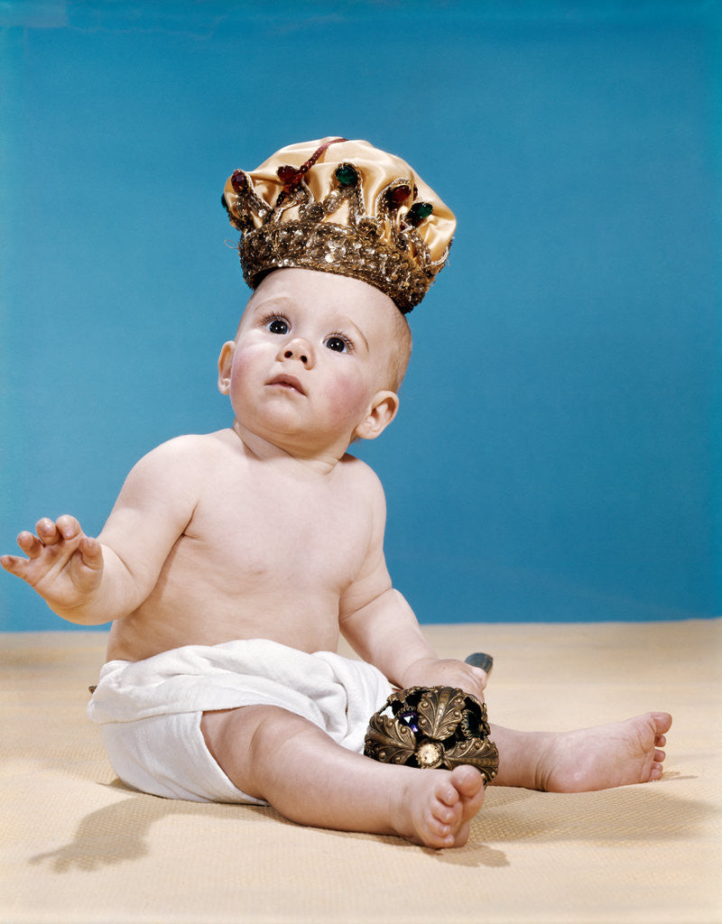 Detail of 1960s baby wearing cloth diaper and crown holding a scepter by Anonymous