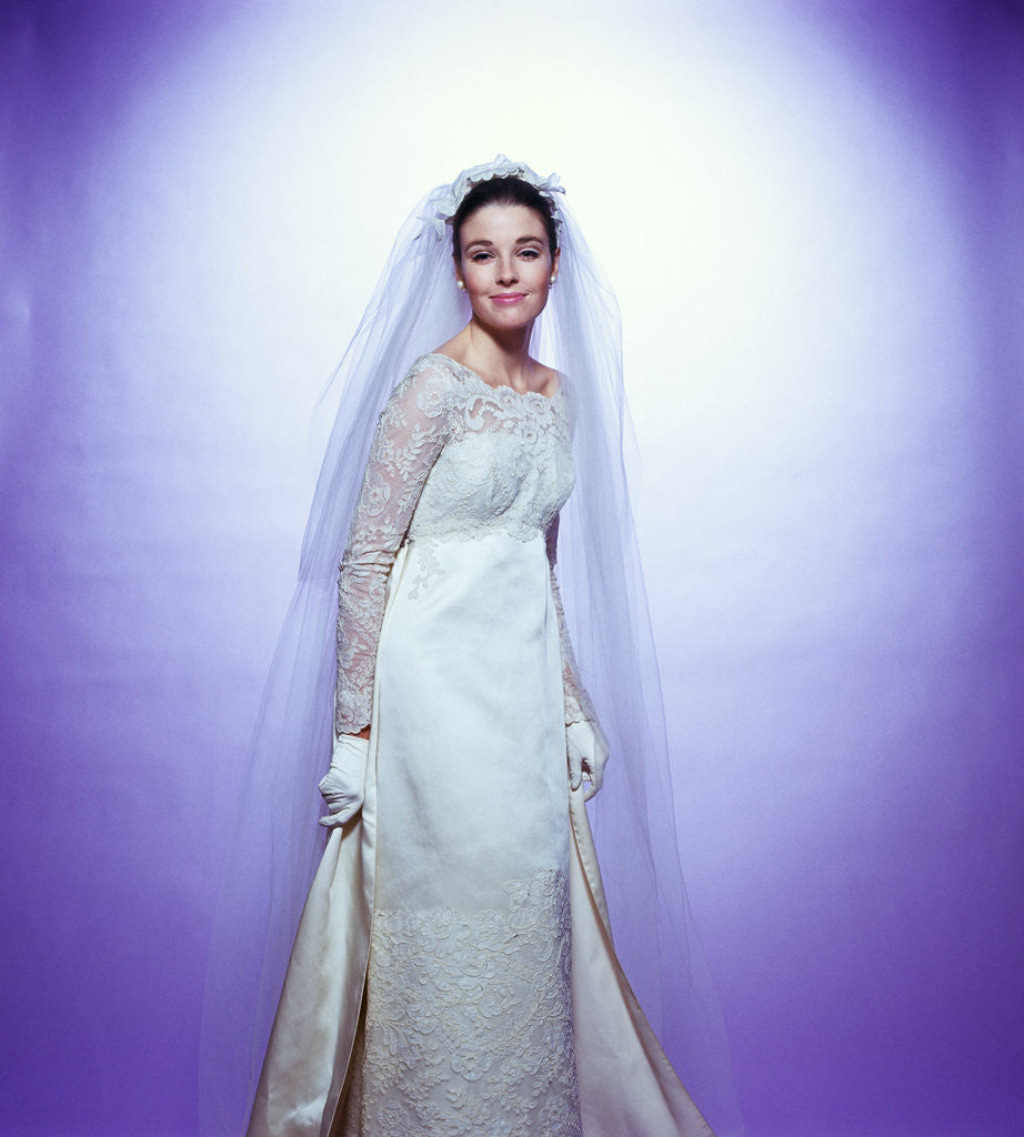 Detail of 1960s young woman bride portrait bridal veil empire waist gown lace bodice by Corbis