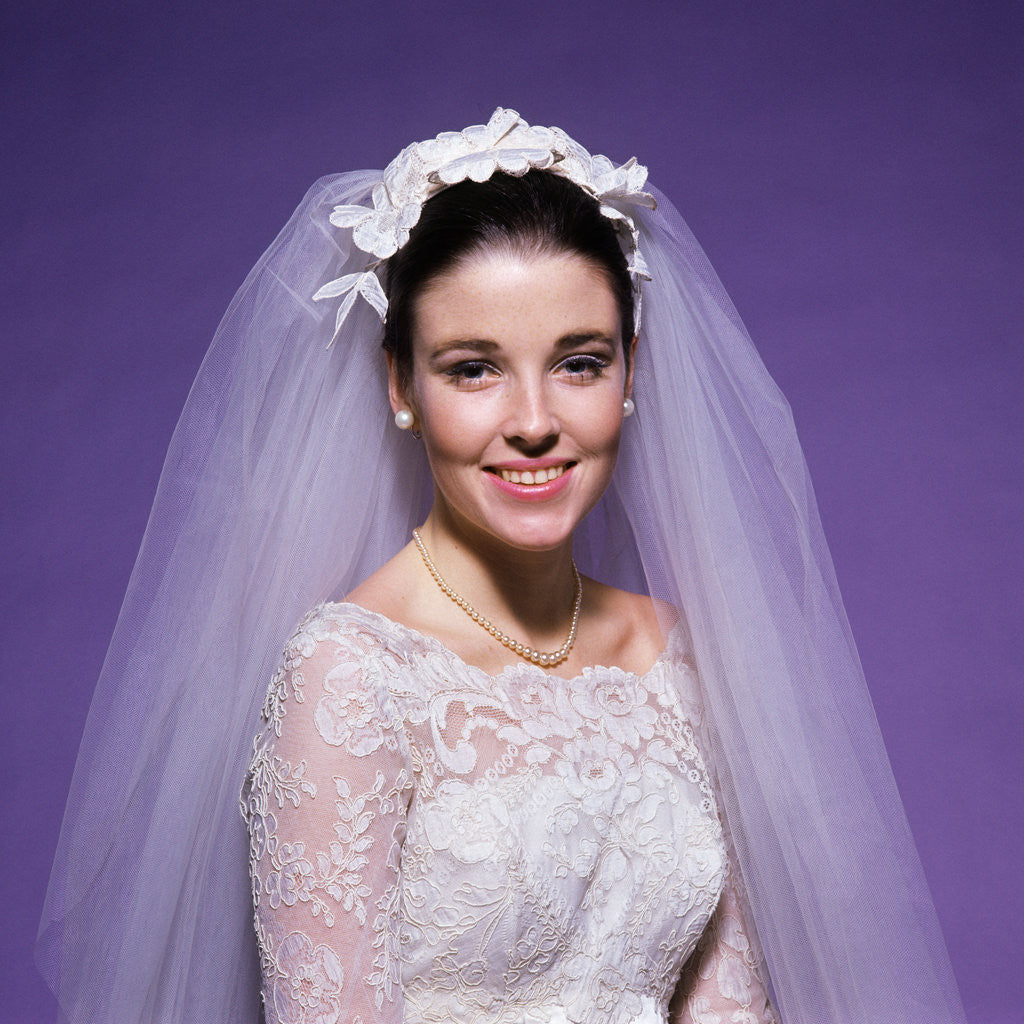 Detail of 1960s young woman bride portrait bridal veil head shoulders smiling pearls by Anonymous