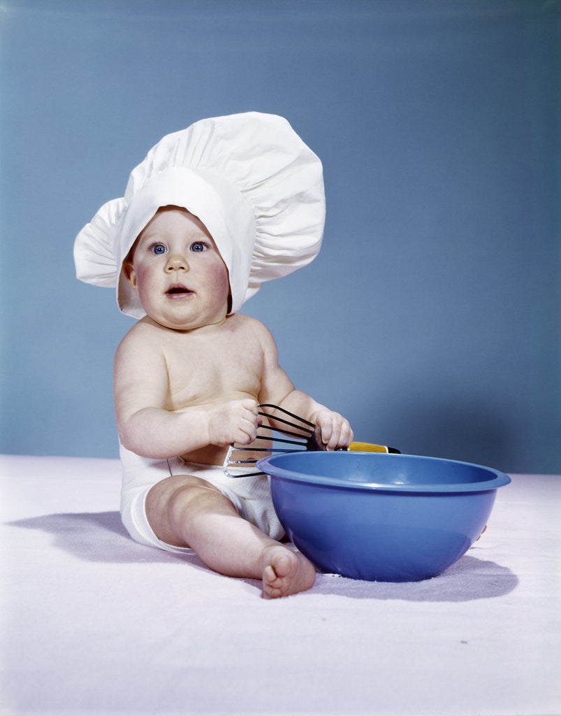 Detail of 1950s 1960s baby wearing chef hat toque holding spatula blue mixing bowl by Anonymous