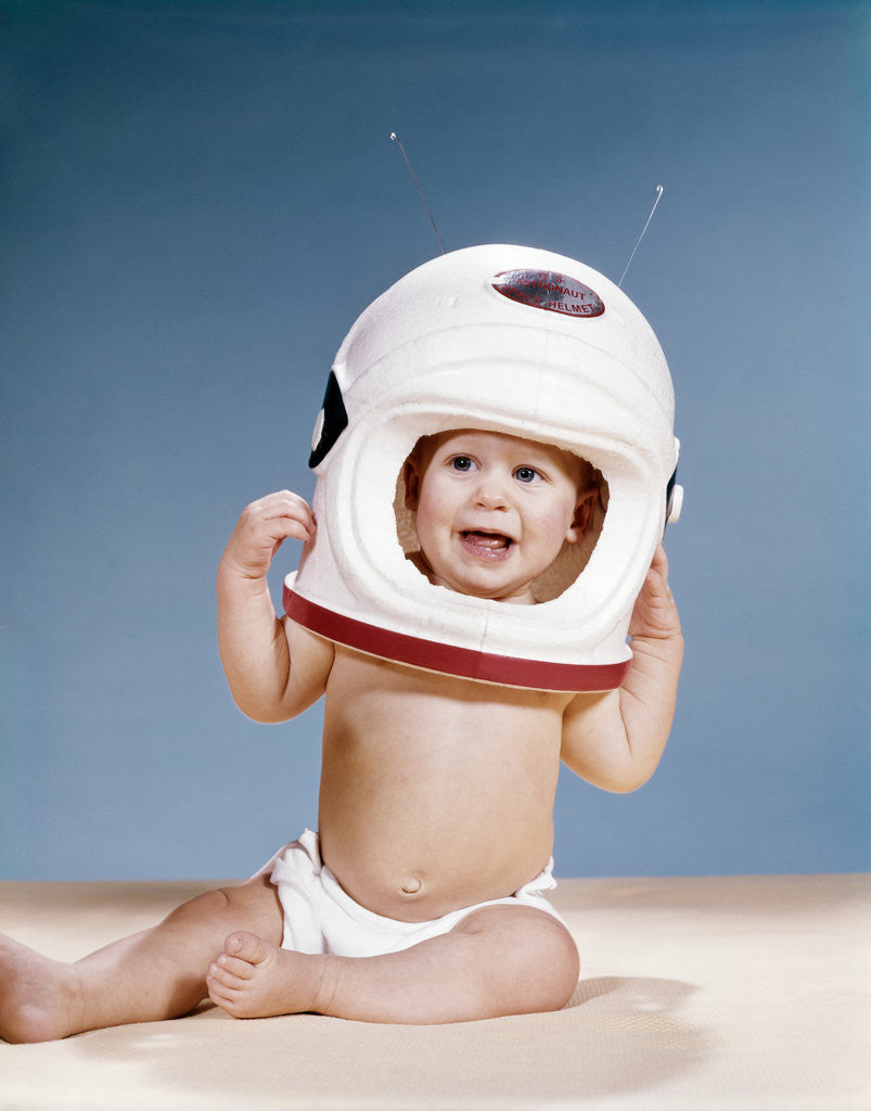 Detail of 1960s baby wearing styrofoam astronaut helmet by Anonymous