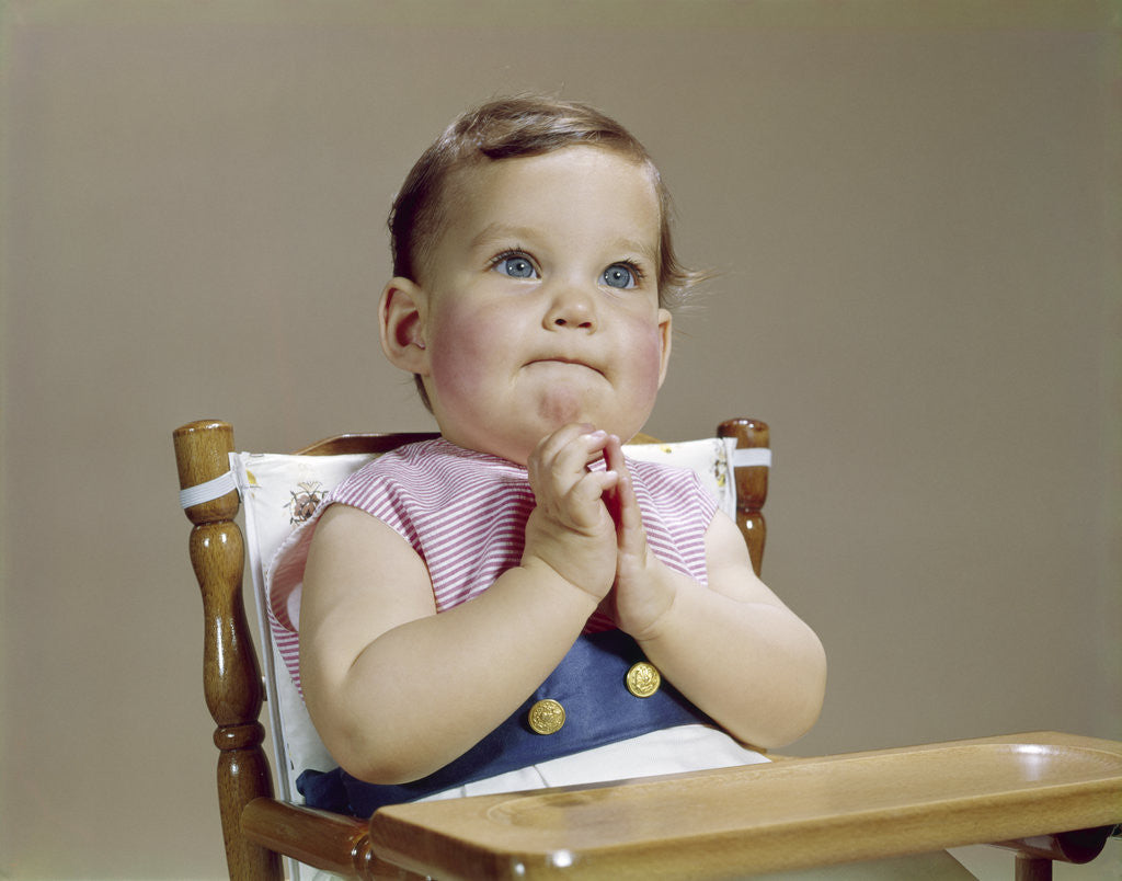 Detail of 1960s baby hands together at chin thinking thoughtful facial expression by Anonymous