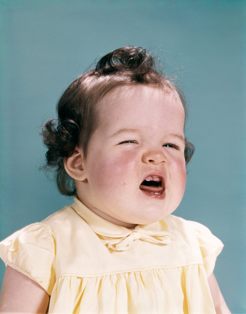Detail of 1950s 1960s unhappy crying baby mouth open showing new teeth teething pain by Anonymous