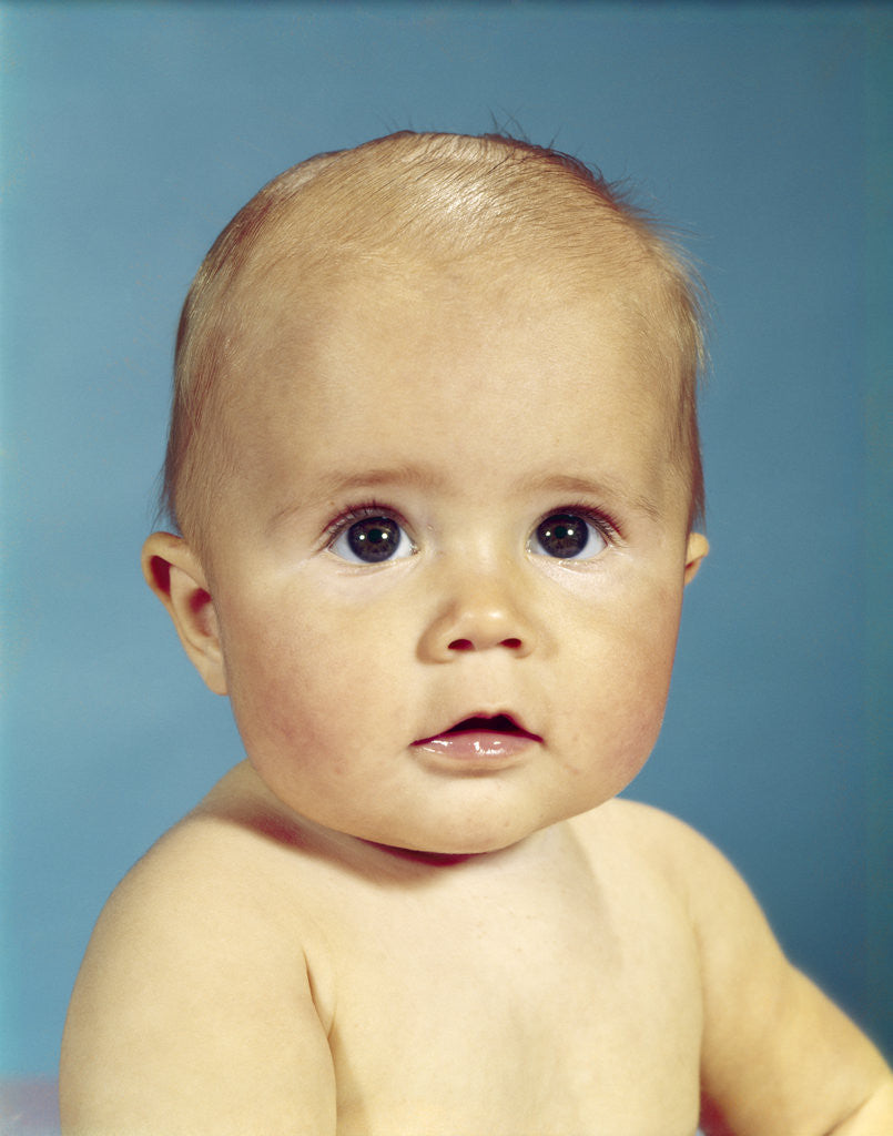Detail of 1960s portrait adorable sincere baby looking at camera by Anonymous
