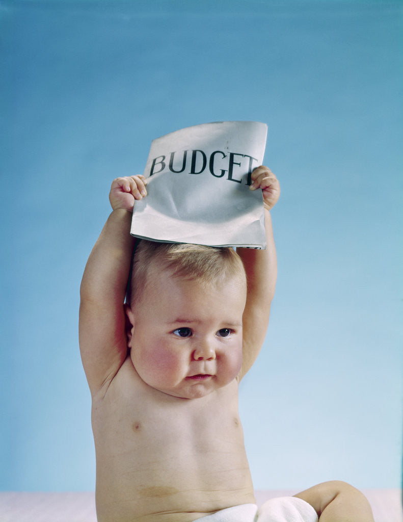 Detail of 1960s baby holding budget sign above his head by Corbis