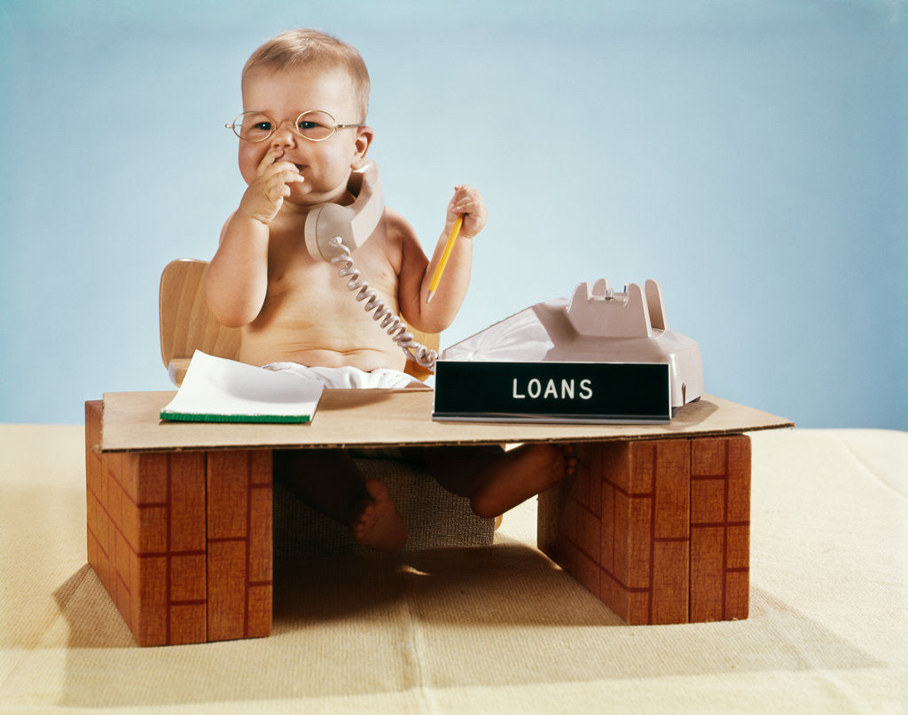 Detail of 1960s baby businessman diaper sitting at loan desk wearing eyeglasses talking on telephone by Anonymous