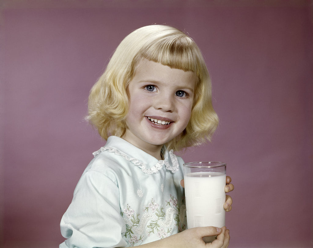 Detail of 1960s girl glass milk dairy smile looking at camera by Anonymous