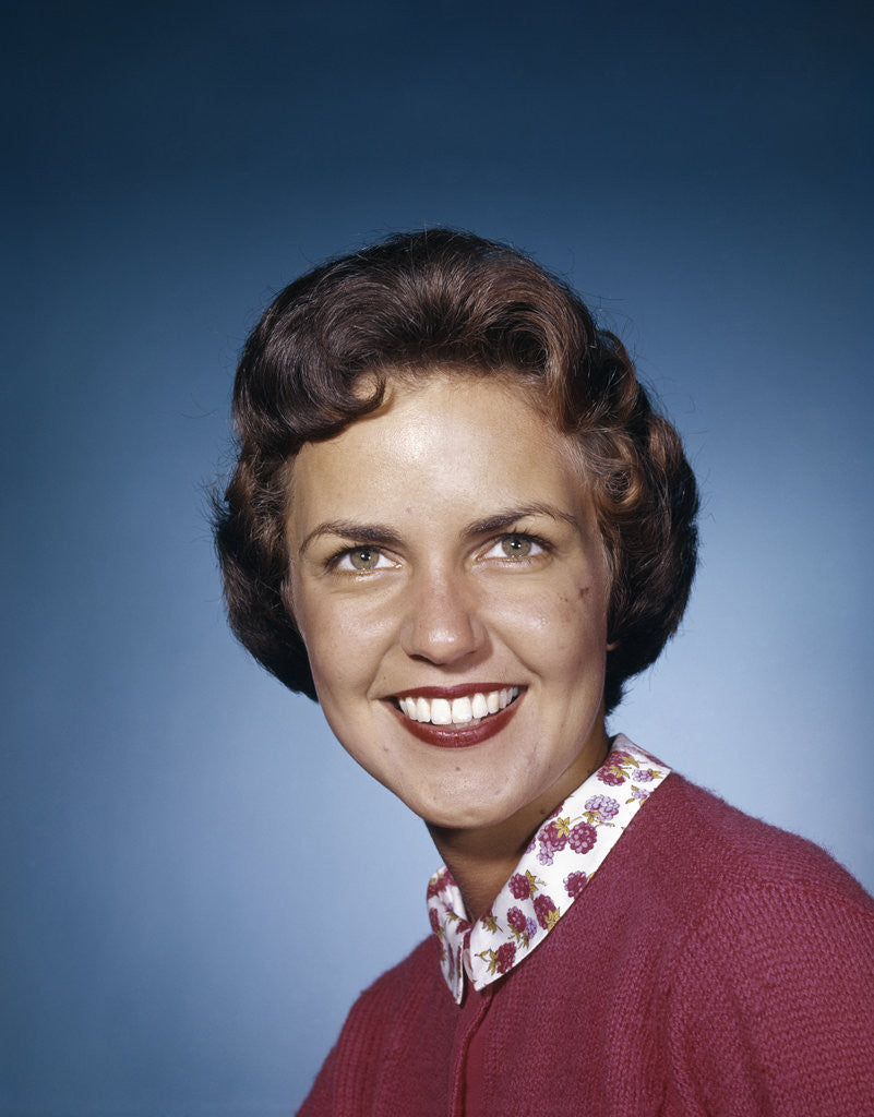 Detail of 1960s portrait smiling brunette woman wearing red sweater looking at camera by Anonymous