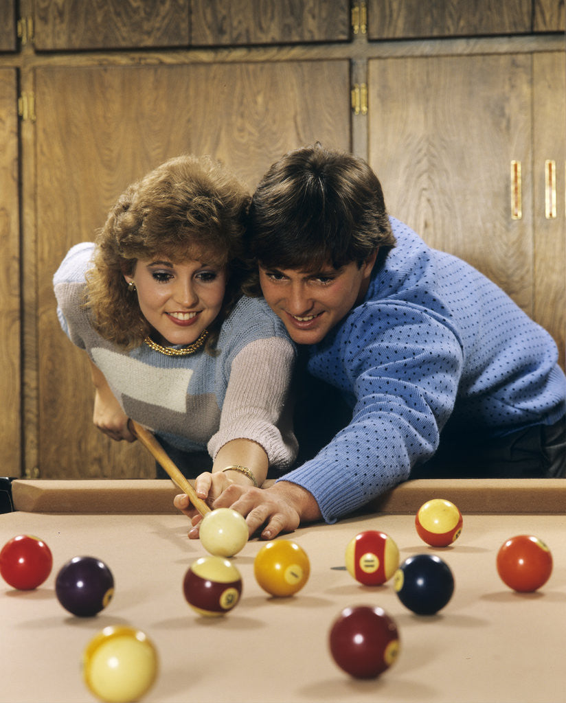 Detail of 1980s teen couple playing pool by Corbis