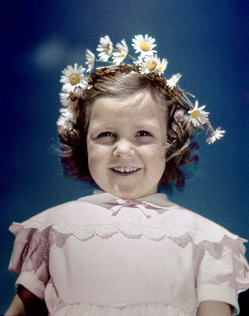 Detail of 1940s portrait smiling little girl wearing yellow and white crown of daisy flowers by Anonymous