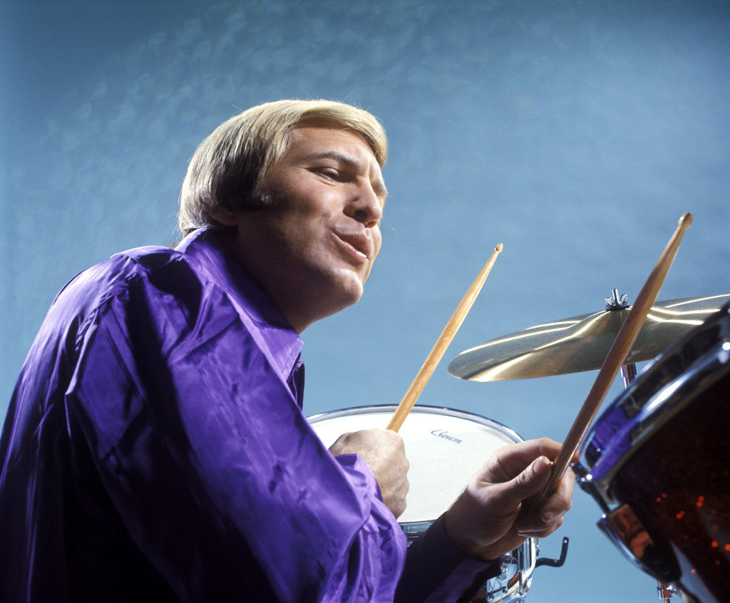 Detail of 1970s musician blond man playing drums wearing purple shirt by Corbis