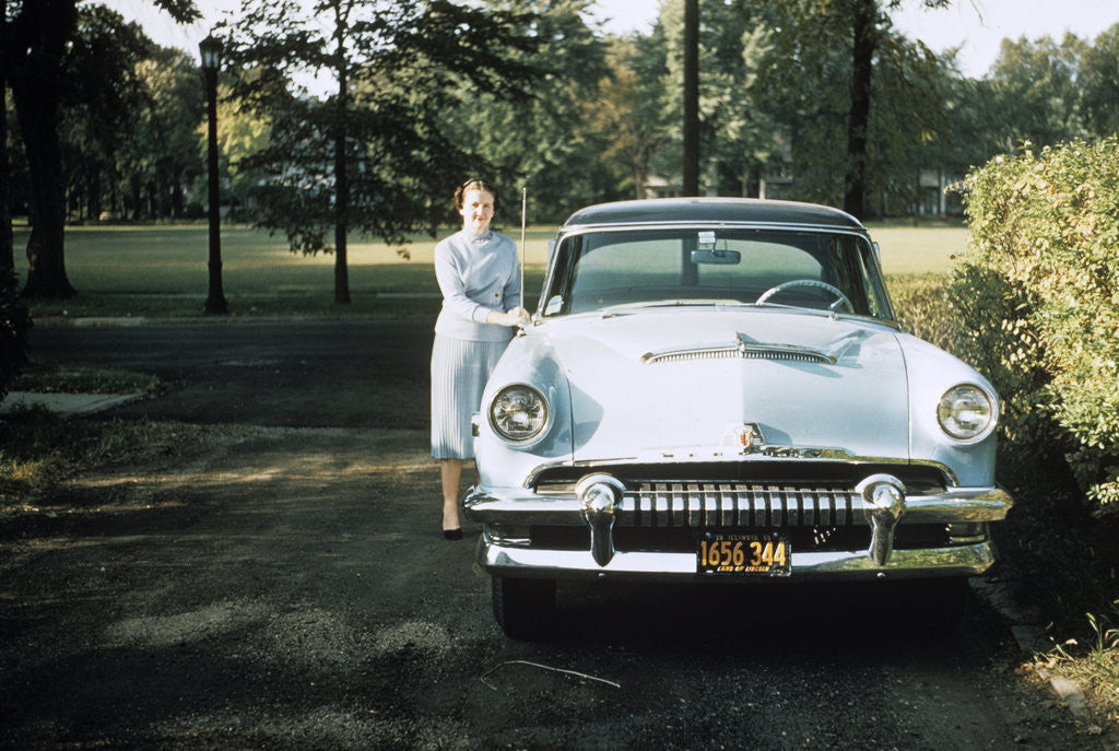 Detail of 1950s 1955 woman standing beside 1954 mercury automobile by Anonymous