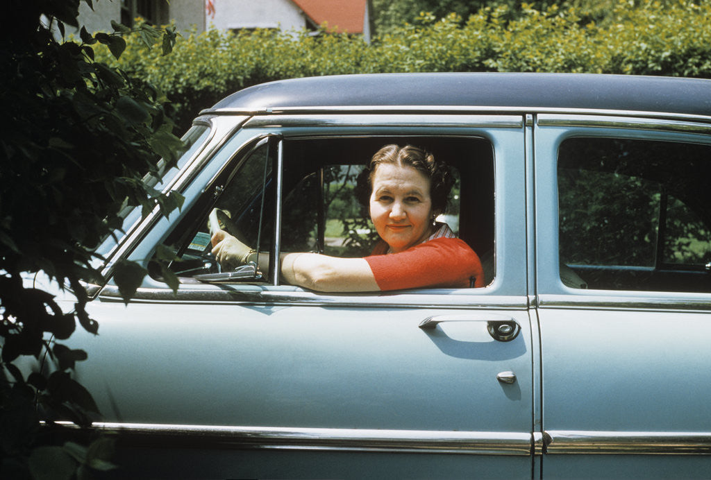 Detail of 1950s woman driver looking out of car window by Corbis