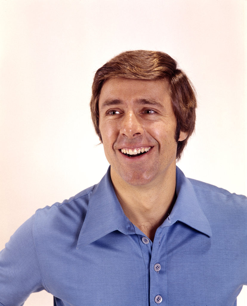 Detail of 1970s man portrait head shoulders blue shirt laughing toothy smile by Anonymous