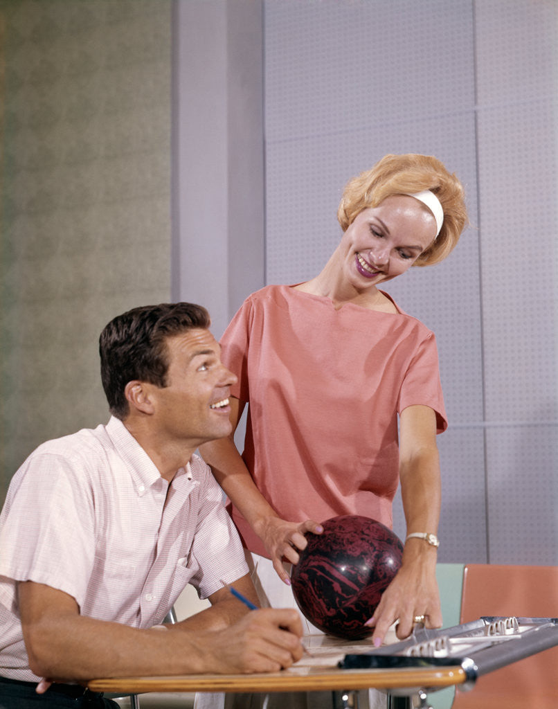 Detail of 1960s couple husband wife bowling checking the score indoor by Anonymous