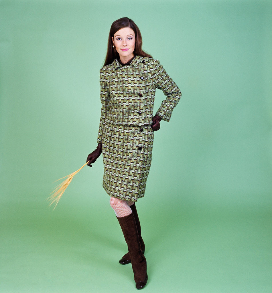 1960s young woman modeling green wool knit two piece suit fishnet stockings boots full length clothe by Corbis