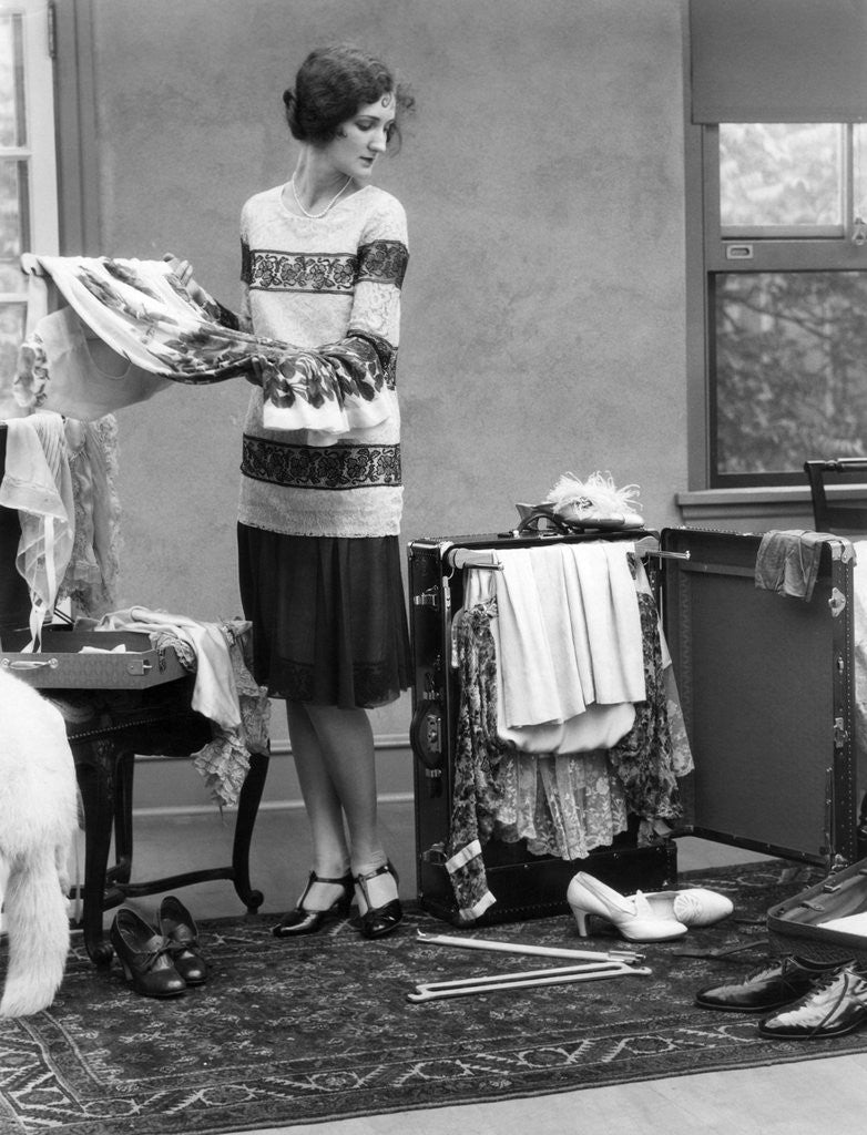 Detail of 1920s woman packing clothes for travel by Anonymous
