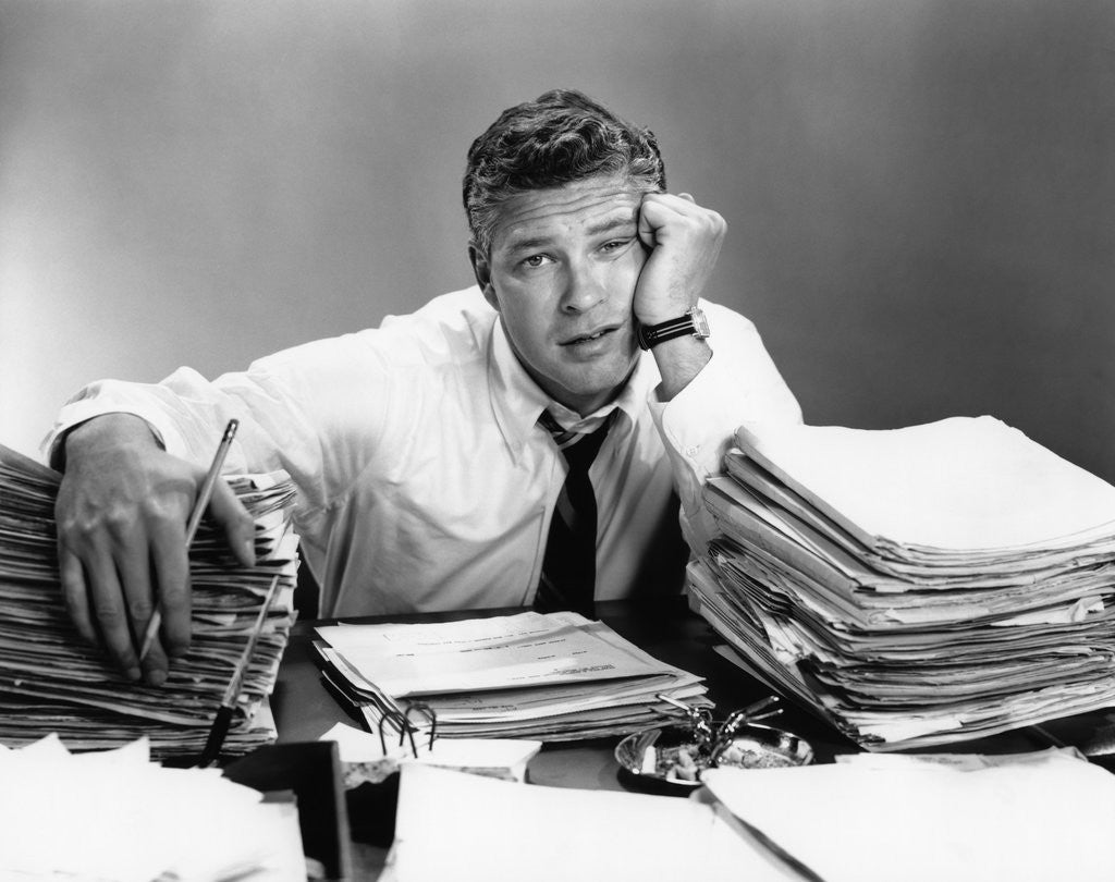 Detail of 1950s portrait man overworked with desk full of papers by Anonymous