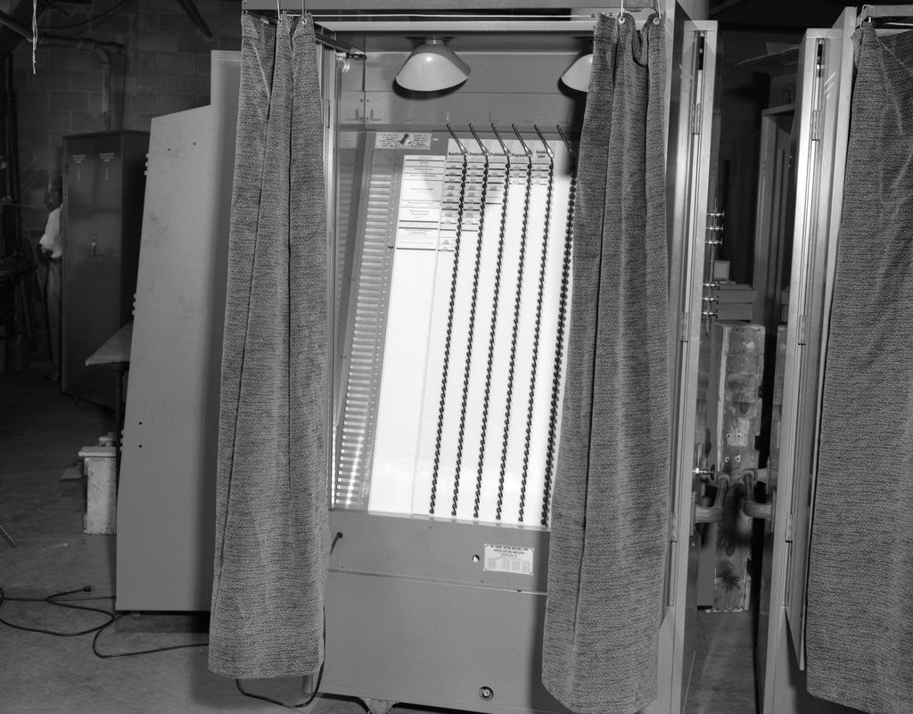 Detail of 1950s voting booth machine with curtain by Corbis