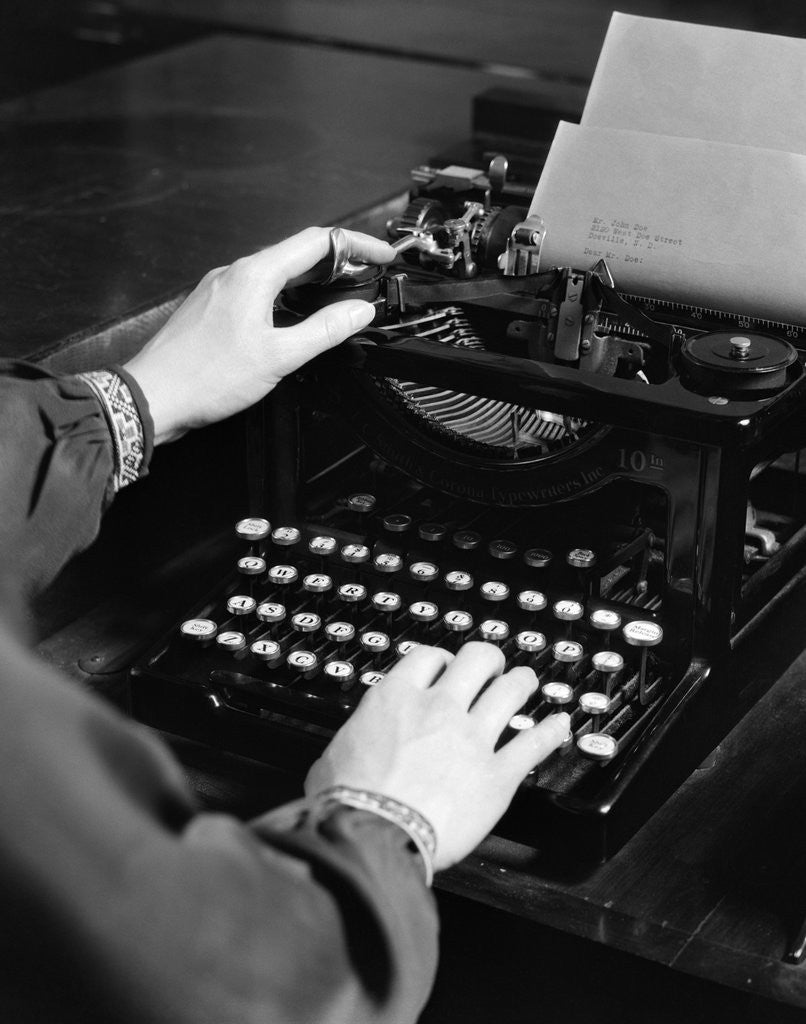 Detail of 1930s woman's hands typing business letter at manual typewriter by Anonymous