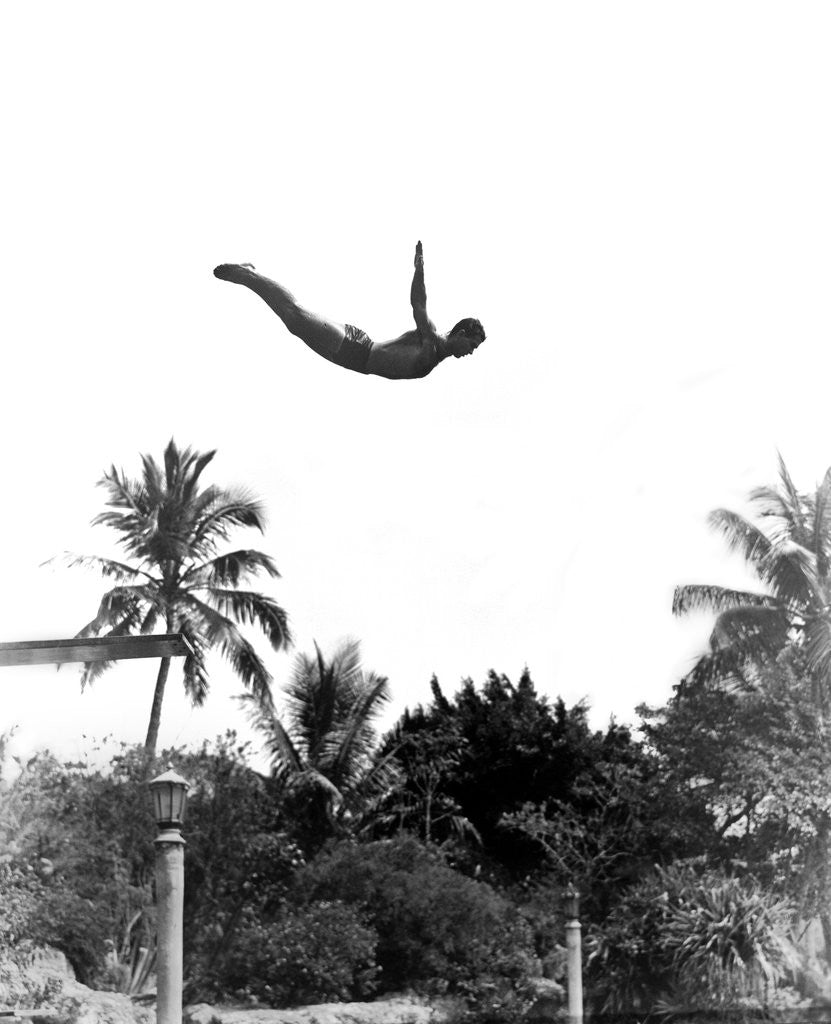 Detail of 1940s man poised midair arms out jumping from diving board into pool by Anonymous
