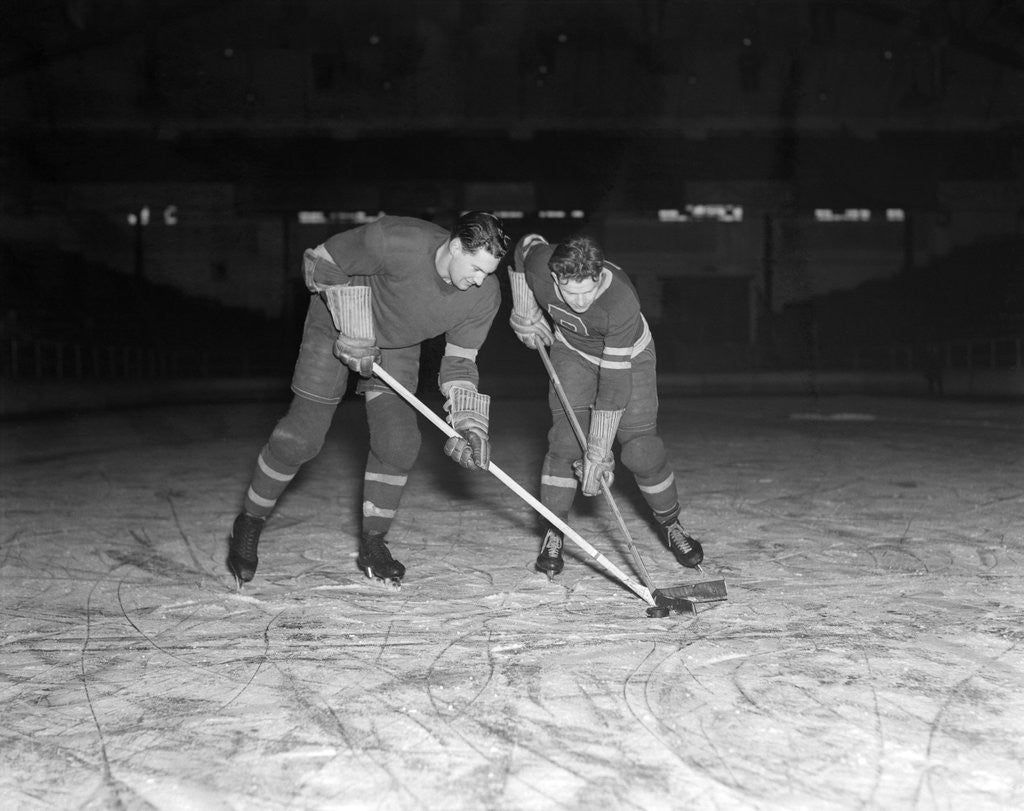 Detail of 1940s 1950s ice hockey players fighting for the puck by Corbis