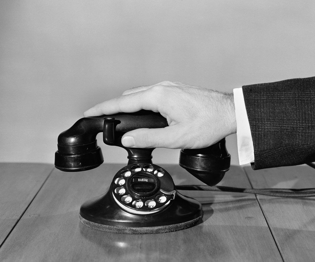Detail of 1930s 1940s man's hand on telephone by Anonymous