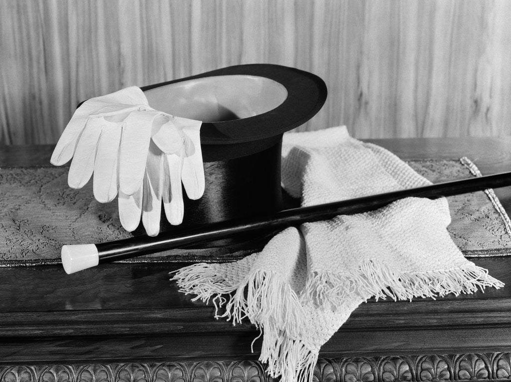 Detail of 1920s 1930s man's formal evening wear top hat white gloves scarf and cane for night on the town by Corbis
