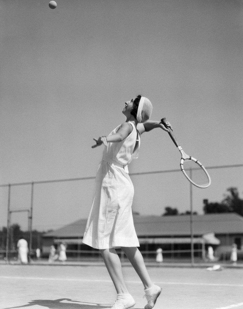 Detail of 1930s woman playing tennis about to hit ball with racket by Anonymous