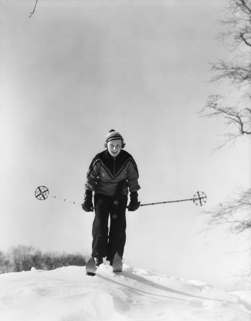 Detail of 1930s woman holding ski poles skiing in snow by Anonymous