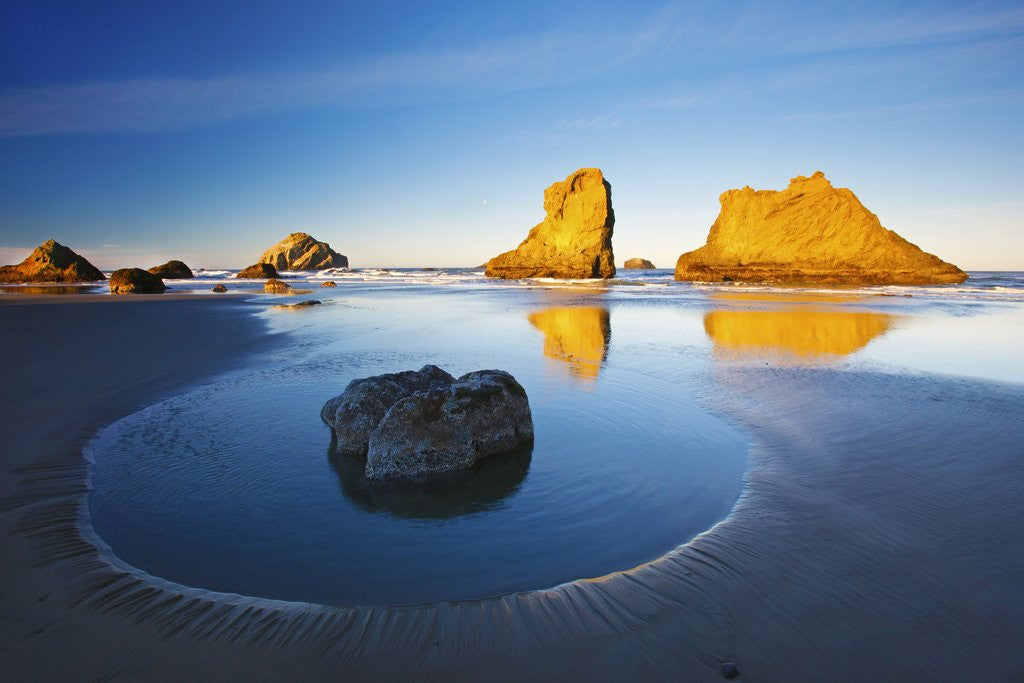 Detail of moon set over rock formations reflecting in tide pools at low tide, Bandon Beach, Oregon Coast, Paci by Corbis