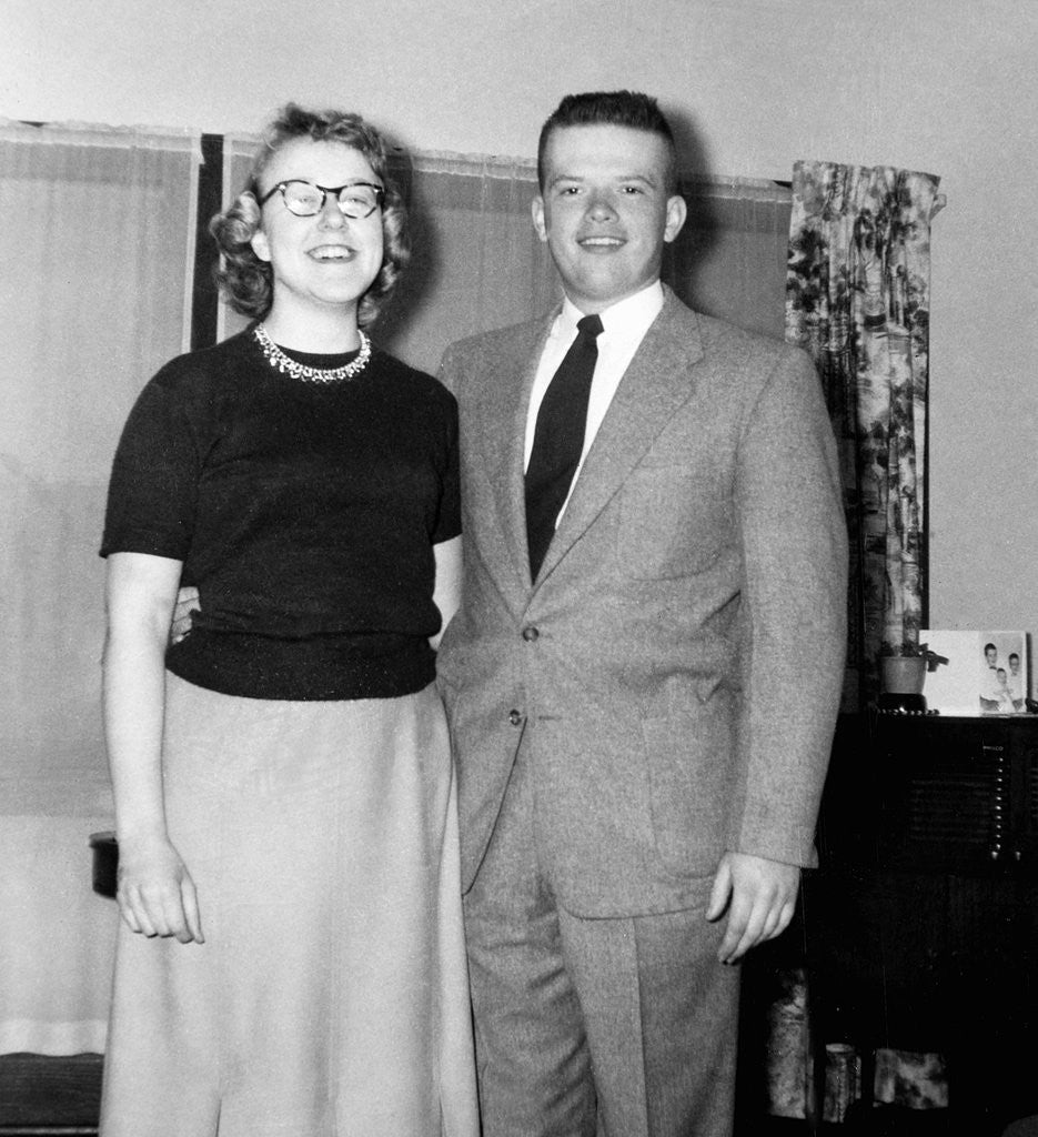 Detail of Young newlyweds smile for a portrait, ca. 1956. by Anonymous