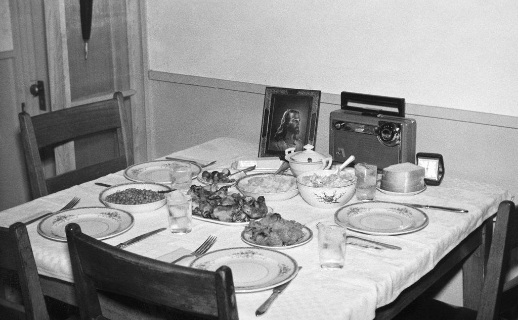 Detail of Jesus watches over the dinner table, ca. 1956. by Corbis