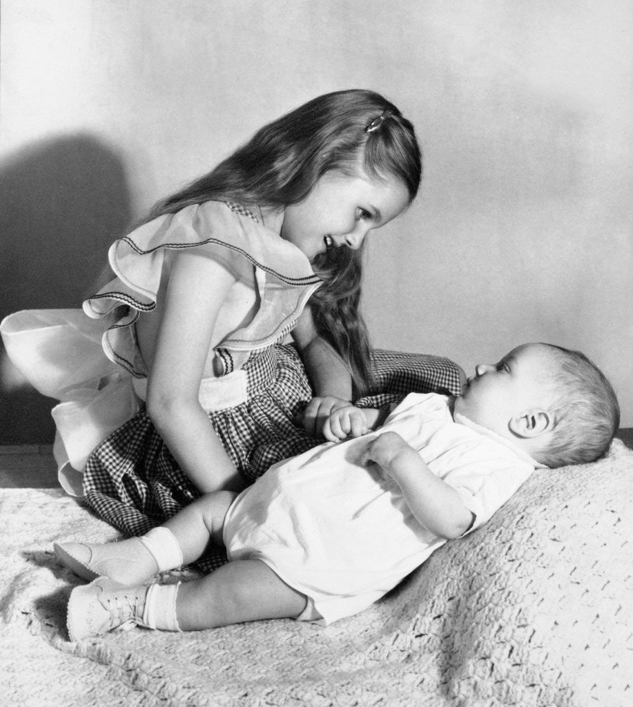 Detail of Big sister looks down on her baby brother, ca. 1948 by Anonymous