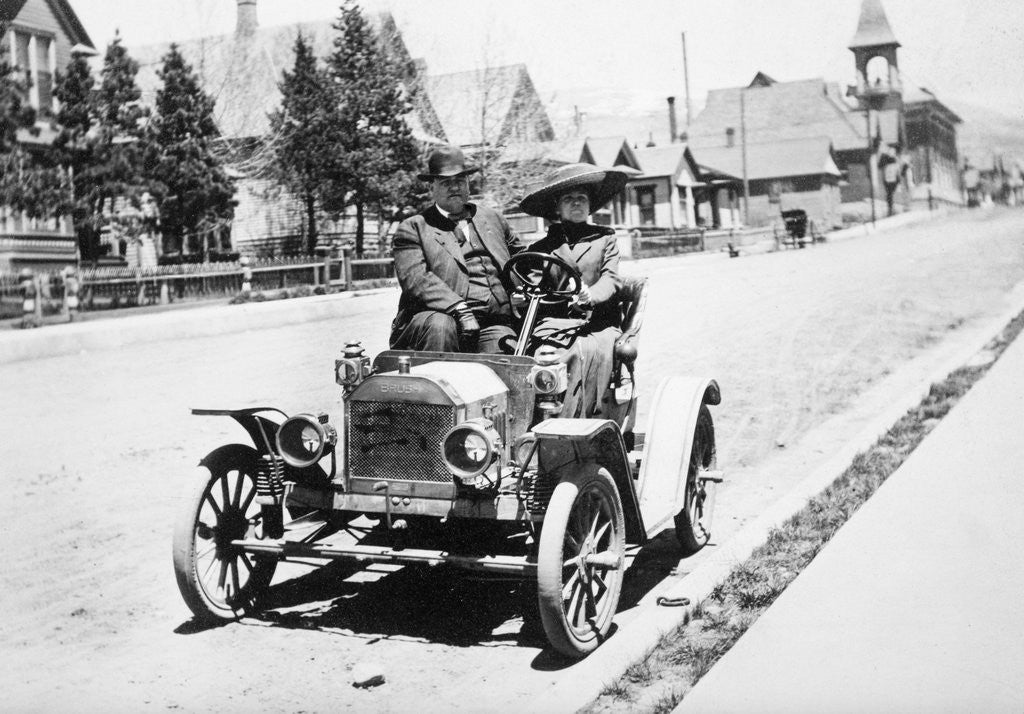 Mature couple in a car, ca. 1910 by Corbis