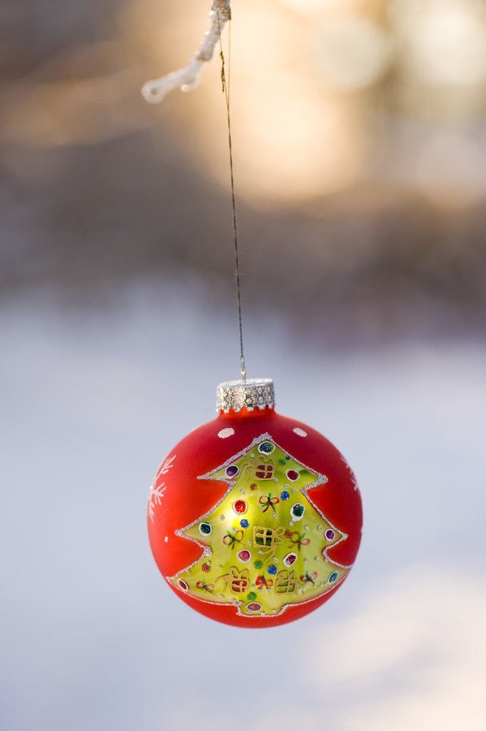 Detail of Close-up of golden Christmas tree on red bauble against blurred background by Anonymous