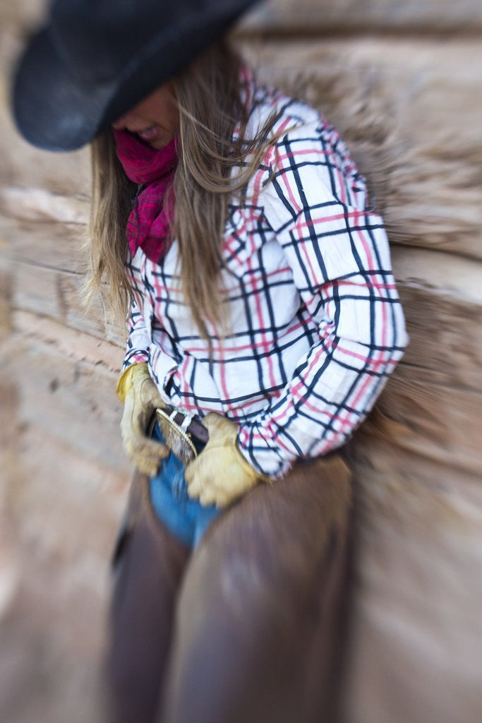 Detail of Cowgirl outside cabin by Anonymous