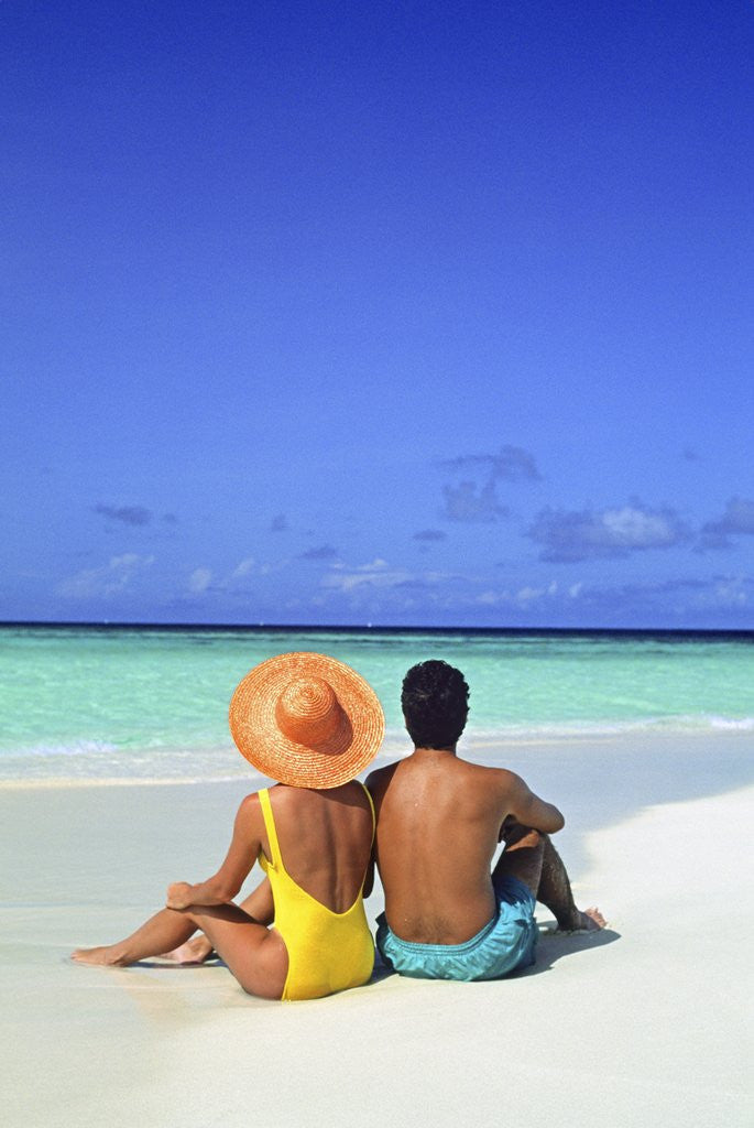Detail of 1990s Man And Woman Sitting On The Beach Facing The Water Mopion Island, Grenadines, West Indies by Anonymous