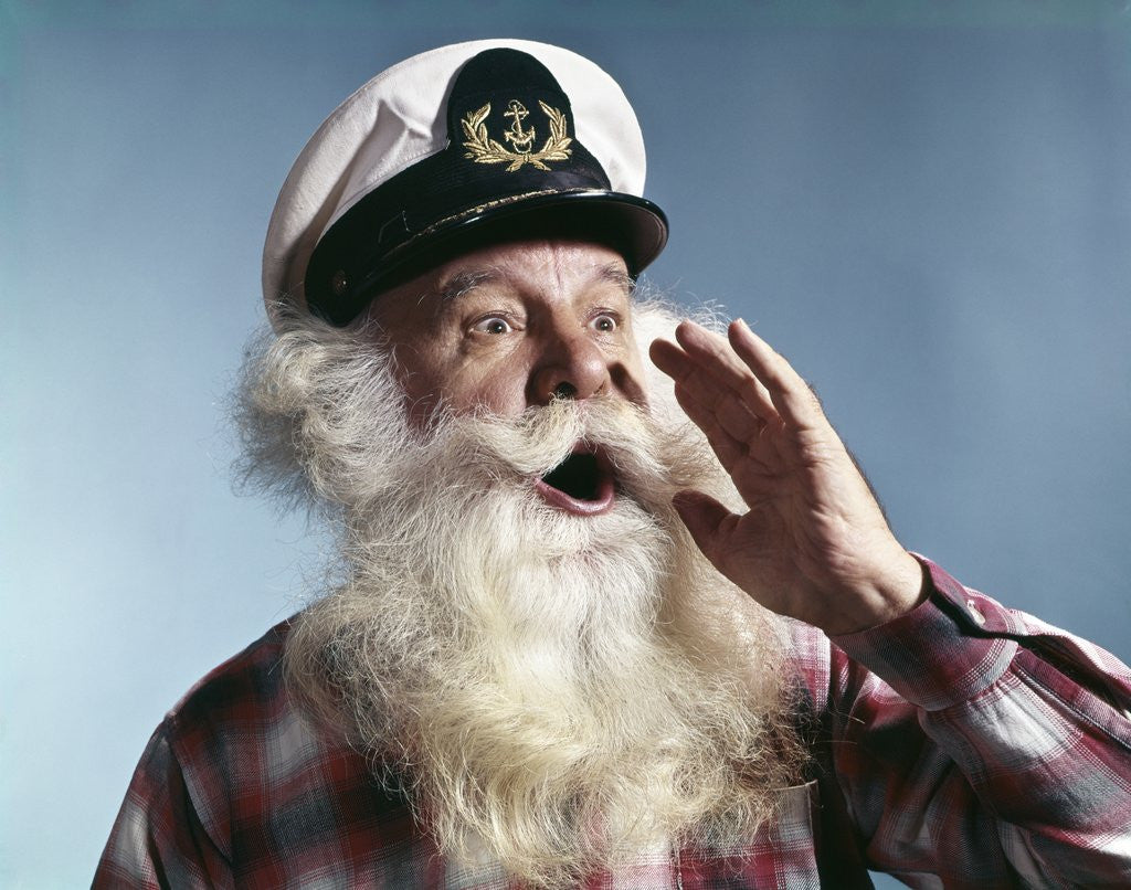 Detail of 1960s Senior Man Full White Beard Wear Ship Captains Hat Shouting With Hand Cupped To Mouth by Anonymous