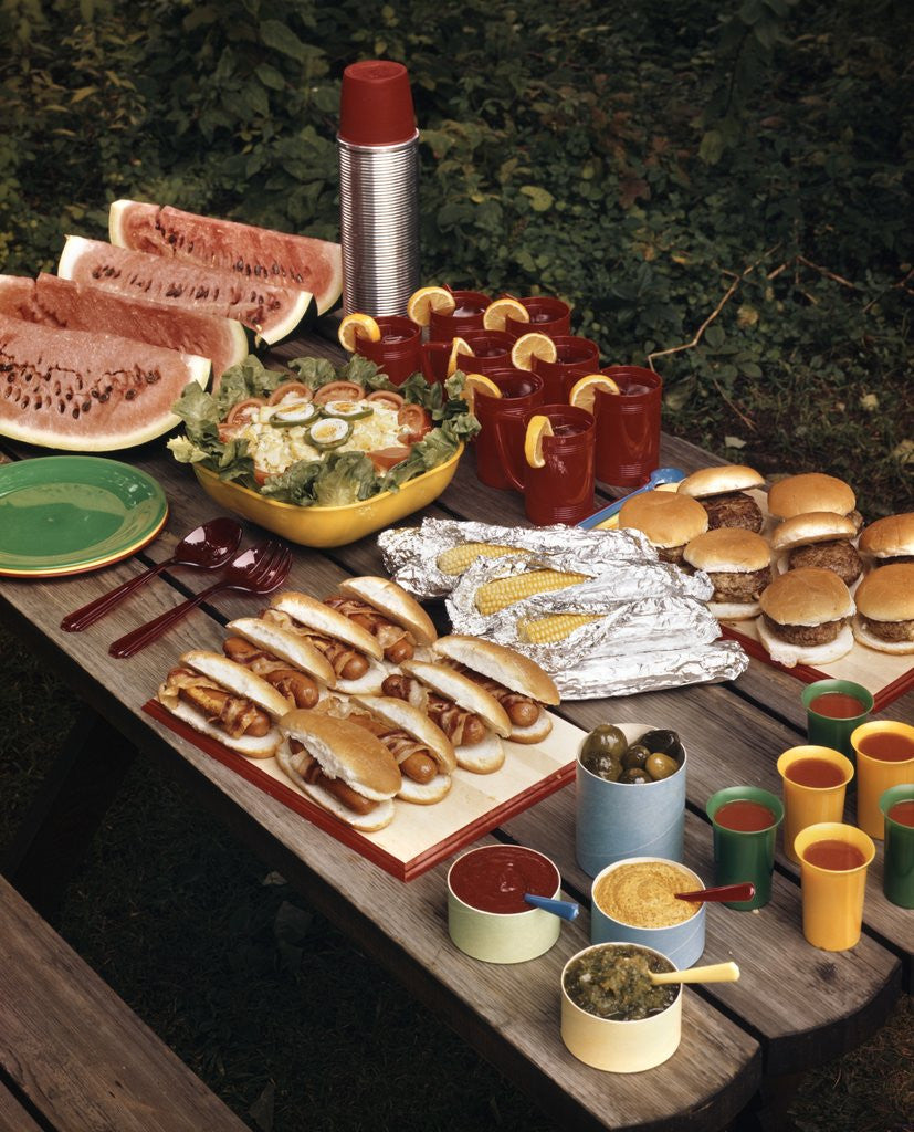 Detail of 1950s Picnic Table Top Full Of Food Corn Hot Dogs Hamburgers Watermelon Salad Thermos Condiments by Anonymous